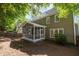 Charming home featuring a screened porch, backyard, and lush, mature trees at 2309 Clerestory Pl, Raleigh, NC 27615
