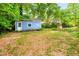 Backyard shed and well surrounded by mature trees at 2509 Elderwood Ln, Burlington, NC 27215
