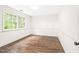 Well-lit bedroom with hardwood floors and a large window providing ample natural light at 2509 Elderwood Ln, Burlington, NC 27215
