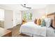 Comfortable bedroom with hardwood floors, closet, and a sunny window with natural light at 2509 Elderwood Ln, Burlington, NC 27215