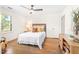 Comfortable bedroom featuring a ceiling fan and hardwood floors with an adjacent closet and window at 2509 Elderwood Ln, Burlington, NC 27215