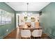 Elegant dining room boasting modern lighting, a dining table, and stylish chairs adjoining a modern kitchen at 2509 Elderwood Ln, Burlington, NC 27215