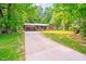 Ranch style home with brick facade, attached garage, and a long driveway at 2509 Elderwood Ln, Burlington, NC 27215