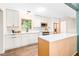 Bright kitchen featuring modern cabinetry, stainless steel appliances, an island, and hardwood floors at 2509 Elderwood Ln, Burlington, NC 27215