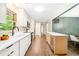 A well-lit kitchen featuring stainless steel appliances, quartz countertops, white cabinetry and hardwood floors at 2509 Elderwood Ln, Burlington, NC 27215