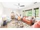 Inviting living room with hardwood floors, large windows, comfortable seating, and an elegant ceiling fan at 2509 Elderwood Ln, Burlington, NC 27215