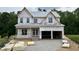 Under-construction two-story home featuring an attached two-car garage and a covered porch at 2521 Terri Creek Dr # 25, Fuquay Varina, NC 27526