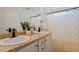 Modern bathroom with double sink vanity and a shower-tub combination with neutral-patterned curtain at 274 Tuscarora Ln, Clayton, NC 27520