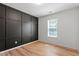 This bedroom includes a dark accent wall with sleek laminate floors, as well as one window for natural light at 274 Tuscarora Ln, Clayton, NC 27520
