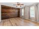 Spacious bedroom featuring an accent wall with hardwood laminate floors throughout, plus plenty of natural light at 274 Tuscarora Ln, Clayton, NC 27520