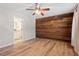 Primary bedroom features wood-look floors and custom wood accent wall with adjoining bathroom at 274 Tuscarora Ln, Clayton, NC 27520