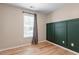This cozy bedroom offers wood floors, natural light, and a green accent wall with built-in storage at 274 Tuscarora Ln, Clayton, NC 27520