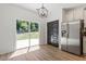Bright dining area with sliding glass doors to the backyard and stainless steel refrigerator at 274 Tuscarora Ln, Clayton, NC 27520