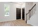 Bright foyer with beautiful flooring, staircase with decorative wrought iron spindles, and natural light at 274 Tuscarora Ln, Clayton, NC 27520