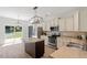 Modern kitchen features stainless steel appliances, granite countertops, an island, and eat-in breakfast area at 274 Tuscarora Ln, Clayton, NC 27520