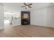 Open-concept living room features fireplace, wood-look flooring, and seamlessly flows into the kitchen at 274 Tuscarora Ln, Clayton, NC 27520