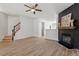 Open-concept living room with fireplace and staircase, creating a welcoming atmosphere at 274 Tuscarora Ln, Clayton, NC 27520
