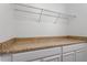 A clean and organized storage area with ample counter space and a wire rack shelf at 274 Tuscarora Ln, Clayton, NC 27520