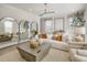 Bright living room with neutral décor, large windows, and comfortable seating arrangement at 2771 Cassius Dr, Apex, NC 27502
