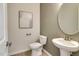 Elegant powder room featuring a pedestal sink, and modern fixtures at 2771 Cassius Dr, Apex, NC 27502