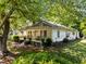 Quaint home with a covered front porch and mature shade trees at 301 N West St St, Cary, NC 27513