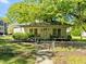 Charming front exterior with covered porch and partially fenced yard at 301 N West St St, Cary, NC 27513