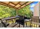 Outdoor deck featuring a covered grill, string lights, and plenty of seating, perfect for entertaining and relaxing in style at 312 Grassy Point Rd, Apex, NC 27502