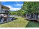 Spacious backyard with mature trees, trampoline, swing set, and patio at 312 Grassy Point Rd, Apex, NC 27502