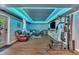 Finished basement featuring a living area, workout equipment, and modern lighting, perfect for relaxation and fitness at 312 Grassy Point Rd, Apex, NC 27502