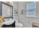 This bathroom features a sleek vanity, a decorative mirror, and a pristine white toilet, offering a blend of style and functionality at 312 Grassy Point Rd, Apex, NC 27502