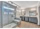 Bathroom with double vanities, tile floors, and a large glass shower at 312 Grassy Point Rd, Apex, NC 27502