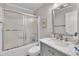 Bathroom with marble topped vanity, chrome fixtures and shower with glass door at 312 Grassy Point Rd, Apex, NC 27502