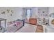 bedroom with bright decorations, a bed, a window, and hardwood floors at 312 Grassy Point Rd, Apex, NC 27502