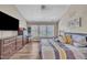 Comfortable bedroom featuring hardwood floors, a ceiling fan, and a large window at 312 Grassy Point Rd, Apex, NC 27502