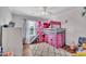 This is a bedroom with a cool loft bed, a pink slide, and a nice hardwood floor at 312 Grassy Point Rd, Apex, NC 27502