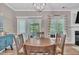 Dining room features a wooden table with views to the backyard and access to the kitchen at 312 Grassy Point Rd, Apex, NC 27502