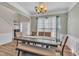 Elegant dining room with wood floors, stylish chandelier, and large table perfect for entertaining guests at 312 Grassy Point Rd, Apex, NC 27502