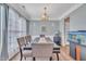 Elegant dining room with wood floors, stylish chandelier, and large table perfect for entertaining guests at 312 Grassy Point Rd, Apex, NC 27502