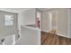 Hallway featuring hardwood floors, a window, and access to a bathroom and bedroom at 312 Grassy Point Rd, Apex, NC 27502