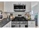 Stainless steel appliances, including oven and microwave, contrast well with the white cabinetry at 312 Grassy Point Rd, Apex, NC 27502