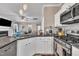 Bright kitchen features stainless steel appliances, granite counters and a view into the open living area at 312 Grassy Point Rd, Apex, NC 27502
