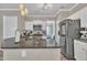Modern kitchen features granite countertops, stainless steel appliances, and ample cabinet space at 312 Grassy Point Rd, Apex, NC 27502