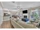 Open living area features a fireplace, dining area, access to the backyard and open concept kitchen at 312 Grassy Point Rd, Apex, NC 27502