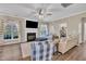 Living room with a fireplace, large windows, and hardwood floors with an open layout design at 312 Grassy Point Rd, Apex, NC 27502