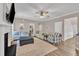 Open living room design with ceiling fan and fireplace, plus comfortable seating and natural light at 312 Grassy Point Rd, Apex, NC 27502