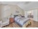 Bedroom featuring a king bed, bedside tables, hardwood floors and access to the bathroom at 312 Grassy Point Rd, Apex, NC 27502