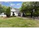 Community pool house with manicured landscaping, mature trees, and a glimpse of the inviting swimming pool at 312 Grassy Point Rd, Apex, NC 27502