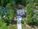 Aerial view of a home with a long driveway surrounded by lush trees and a well-maintained yard at 3627 River Watch Ln, Franklinton, NC 27525