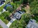 Aerial view of the home with solar panels, surrounded by lush greenery and neighboring houses at 3627 River Watch Ln, Franklinton, NC 27525