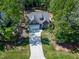 Aerial view of a home with a long driveway surrounded by lush trees and a well-maintained yard at 3627 River Watch Ln, Franklinton, NC 27525